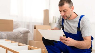 furniture-assembler-installing-shelf-reading-manua-8SCMBC8 furniture-assembler-installing-shelf-reading-manua-8SCMBC8